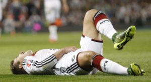 Germany's Mario Goetze sits on the floor after a foul during the Euro 2016 group D qualifying soccer match between Ireland and Germany in Dublin, Ireland, Saturday, Jan. 13, 2001. (AP Photo/Peter Morrison) The Associated Press